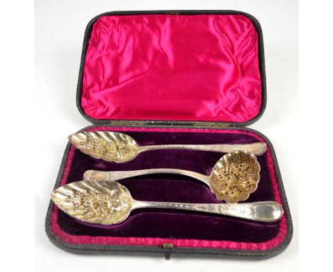 THOMAS WALLIS II; a cased pair of George III hallmarked silver berry spoons with gilt washed repoussé bowls and bright cut st