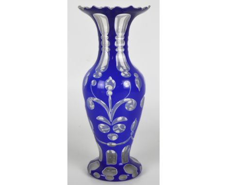 A Bohemian clear glass blue and white enamel overlaid footed baluster vase, height 27.5 cm. CONDITION REPORT: A shaped oval c
