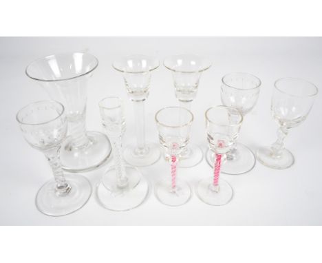 A group of glasses to include a pair of toasting glasses with bell shaped bowls, stem with a double series twist to a folded 