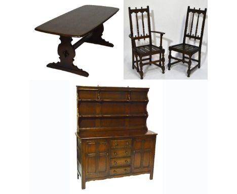 An Ercol "Old Colonial" dark dining room suite comprising a refectory table, dresser with boarded plate rack, two elbow chair