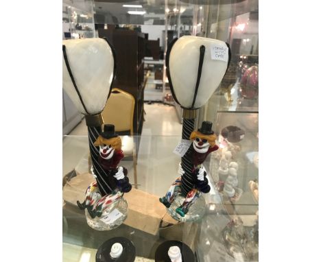 A pair of Murano glass lamps in the form of a clown astride a lamp post