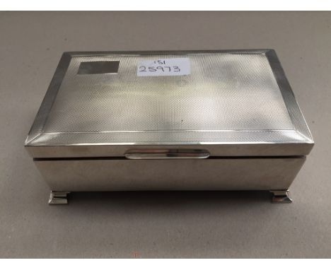A HM silver engine-turned cigarette box