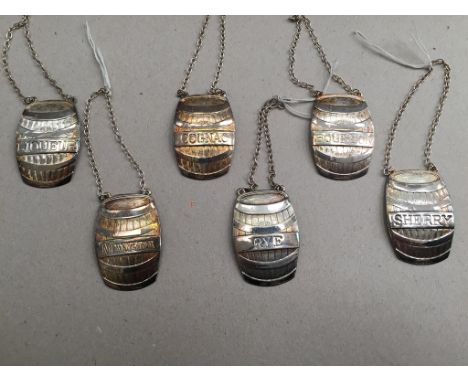 A set of six silver decanter labels