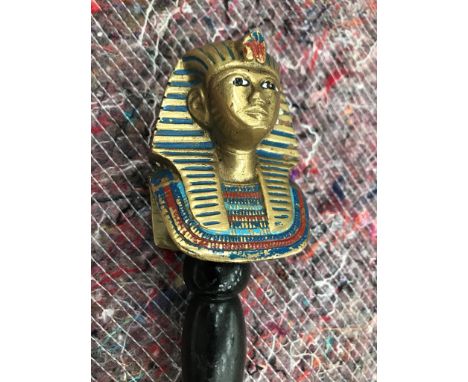 A walking stick with an enamelled brass death mask of Tutankhamun 