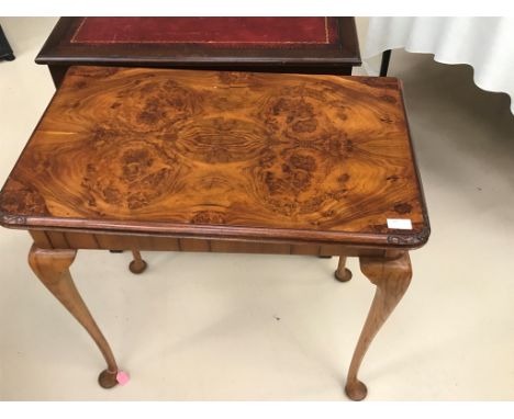 A 1920s walnut revolving top card table on cabriole legs