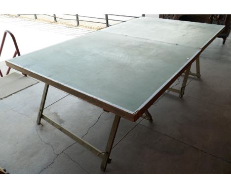 A vintage table tennis table on trestle base 