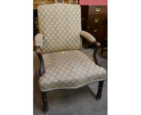 A George III Chippendale style carved mahogany and fabric upholstered Gainsborough chair 