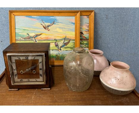 An Art Deco oak mantel clock, lamp shades, two oils on board and a glass jar 