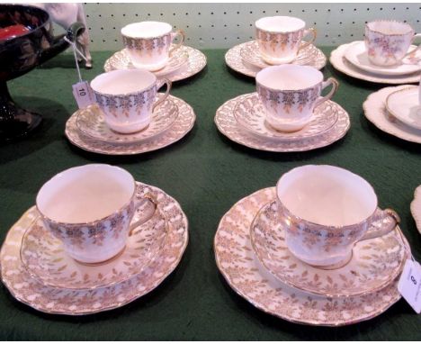 A mid-20th century Imperial bone china set of 8 teacups, saucers and tea plates, each transfer florally gilt decorated.