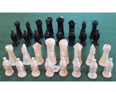 A set of back gloss and white gloss glazed ceramic chessmen.