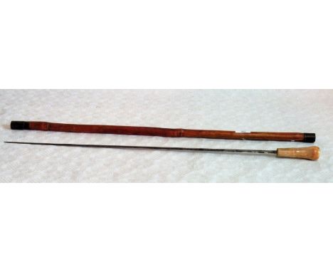 An Edwardian sword stick with indistinctly inscribed lozenge section steel blade, bone handle in a bamboo scabbard.