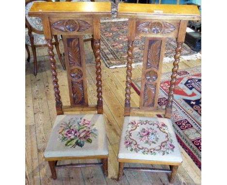 A pair of late Victorian light oak prie-dieu, each having rectangular top with leaf carved frieze and splat within barley twi