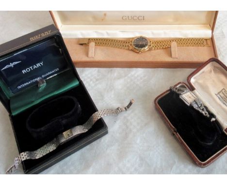 A gilt metal gents mid-size Gucci wristwatch, boxed, together with a lady's Rotary wristwatch and one other, set with marcasi