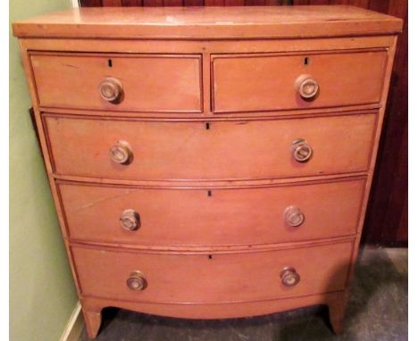 An early 19th century bow front chest of two short and three graduated long drawers, each with turned knop handle on splayed 