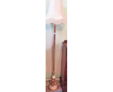 A brass and alabaster standard lamp, the reeded and knopped column on a simulated dolphin and stepped circular plinth with fr