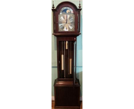 A reproduction longcase clock with a triple train moonphase dial facing an eight day movement.