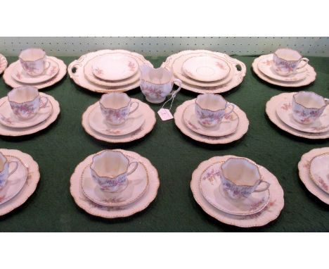 An early 20th century Continental bone china tea service, a part-twelve place setting, comprising: 10 cups, 12 saucers, 12 te