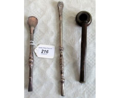 A Mexican silver opium pipe, together with two other pipes.