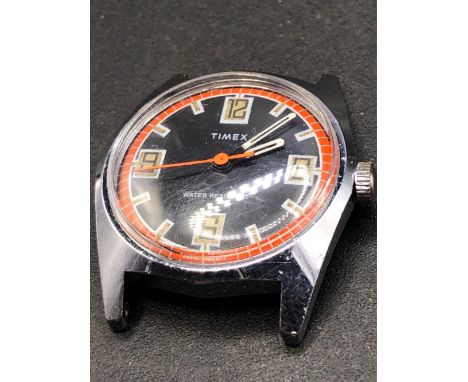 A 1970s Timex watch with red and black dial