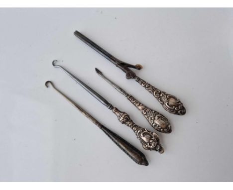 Four silver handled button hooks etc