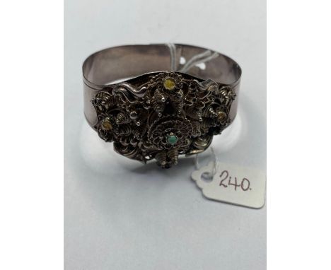 A fancy hallmarked silver buckle bangle with central turquoise  