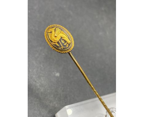 A vintage high carat gold applique winged griffin in two  colour gold stick pin  