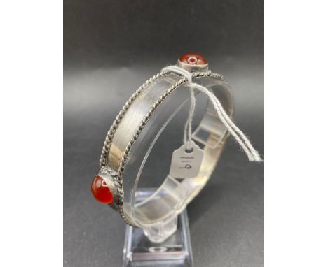 A large silver and carnelian set bangle