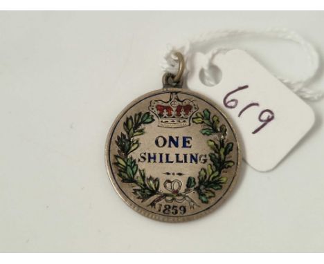 A silver and enamel one shilling pendant