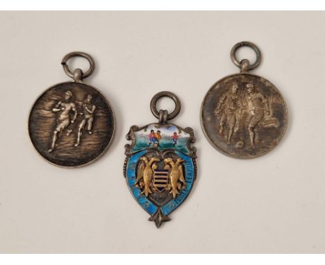 A silver and enamel football medal and two others 29 gms
