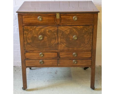 DRESSING TABLE, George III mahogany, circa 1800 with hinged top and interior mirror above two doors and three drawers on bras