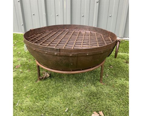 Circular cast iron fire pit, with grateDimensions: Height:&nbsp;34cm&nbsp; Length/Width:&nbsp;60cm&nbsp; Depth/Diameter:&nbsp