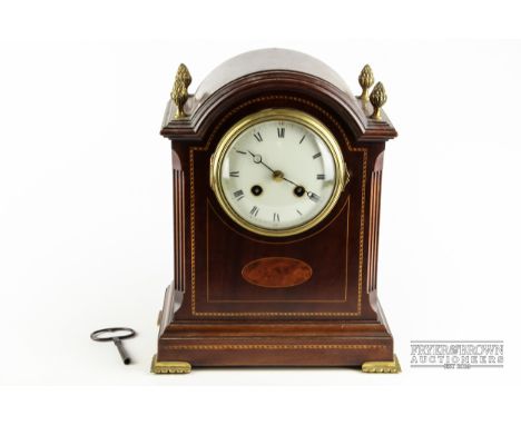 A Edwardian bracket clock, enamel dial, arch top with inlaid stringing and birds eye maple reserve, gilt metal acanthus finia