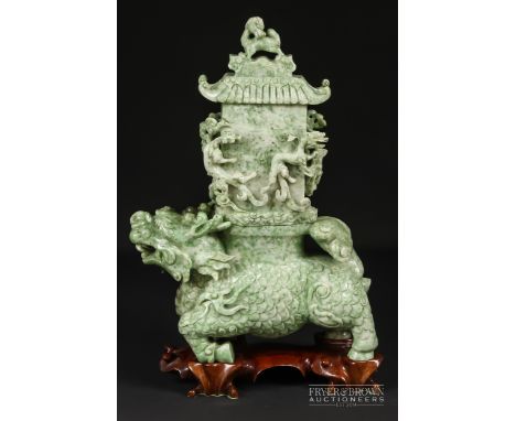 A fine Chinese jadeite chimera form vase and cover, 20th century, the mottled pale apple green jade carved as a prancing chim