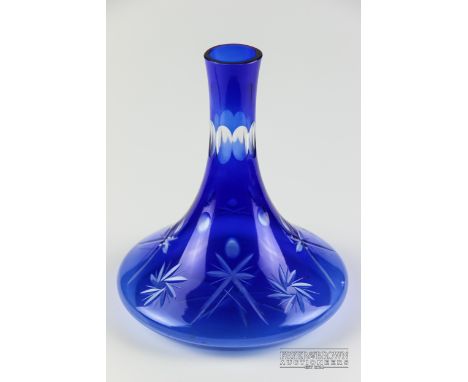 A blue glass vase in the form of a ship's decanter with cut star design