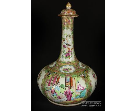 A Canton enamel decorated Chinese porcelain bottle vase and cover, late 19thC, decorated with 'C' scroll panels of figures in