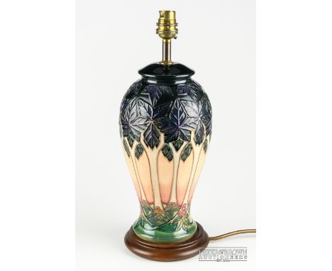 Sally Tuffin for Moorcroft Pottery, a lamp base in Cluny pattern, tube lined with a design of chestnut trees, fitted for elec