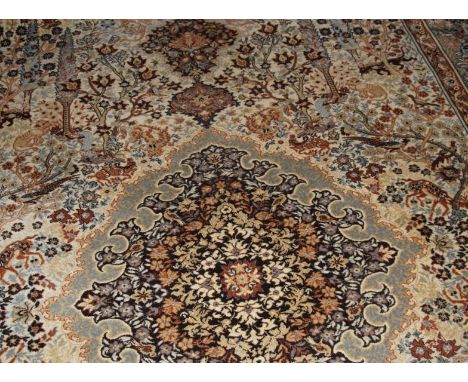 A modern Persian style patterned carpet, with central medallion and floral and fauna designs on a beige ground, 340cm x 250cm