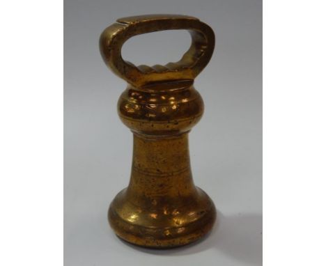 A vintage brass 14lb weight, with loop handle.
