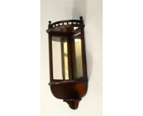 A mahogany mirrored corner shelf bracket, with gallery top and small undershelf, 72cm high, 33cm wide.