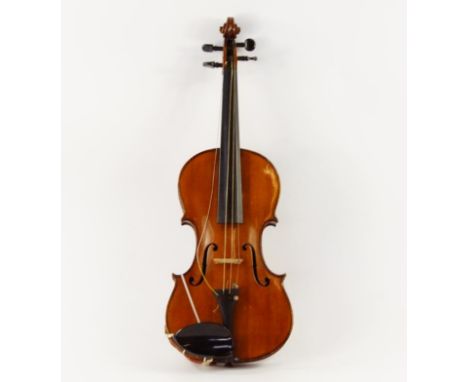 A late 19thC violin, with a figured two piece back and bearing a label inscribed Antonius Stradavarius BB & Co Deutidje Urbei