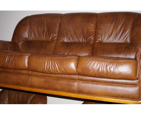 A modern three piece suite, with matching pouffe, upholstered in brown hide.