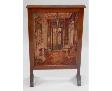 A mahogany framed fire screen, with wool needlework panel depicting an interior scene.