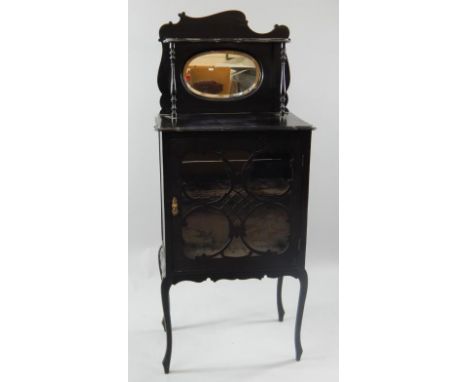 A late Victorian ebonised side cabinet, enclosed by a single glazed door and with two plush lined shelves, the top with a sha