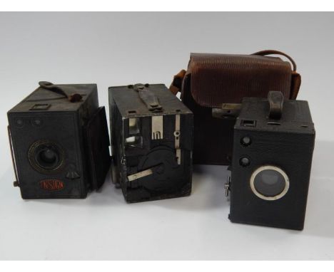 An Ensign box camera, and two others including a Kodak No 2 Brownie box camera and a Zeiss Ikon box camera, one with a leathe