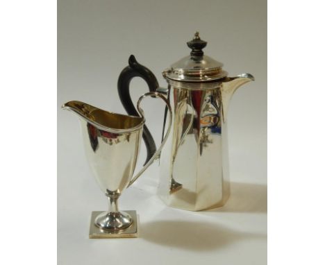 A late Victorian plain silver helmet shaped cream jug, with reeded border in Georgian manner, Chester 1898, and a silver plat