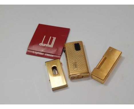 A Dunhill rolled gold cigarette lighter, and a Ronson lighter and a cigar cutter, (3).