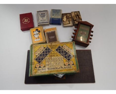 A perpetual calendar, in mahogany case, a set of bone dominoes, Mickey Mouse playing cards and others, etc.