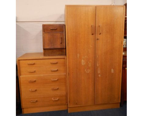 A G Plan light oak bedroom suite, comprising hanging wardrobe and a chest of five drawers, and a small bedside cupboard to ma