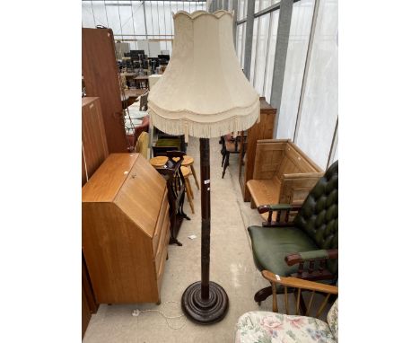 AN ORIENTAL HARDWOOD STANDARD LAMP COMPLETE WITH SHADE 