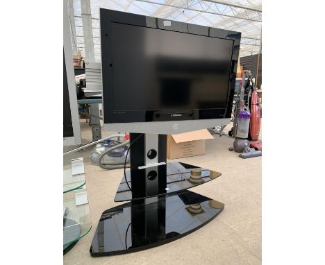 A SAMSUNG 32" TELEVISIOV ON GLASS DISPLAY STAND 